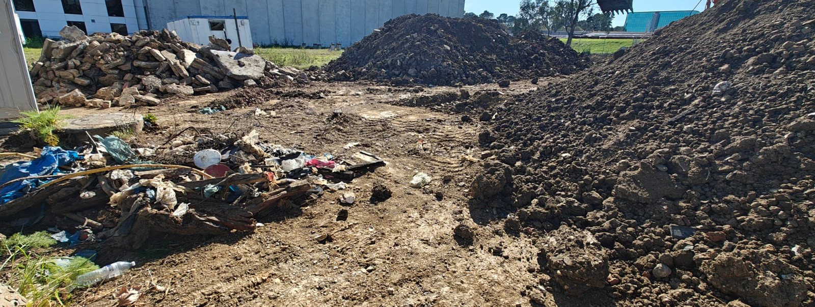 Separate stockpiles of clean soil, concrete, residual mixed fill and general waste after double sifting