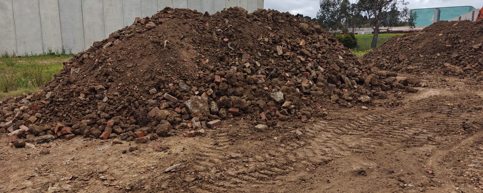 Excavated deep mixed fill containing soil, brick and concrete fragments on a development site